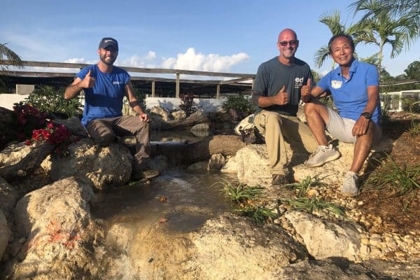 jay-pond-prof Jay Villemarette pictured with Aquascape’s Ed Beaulieu aka The Pond Professor and Ty Park, Founder of Iguanaland at a 2020 pond build in Punta Gorda Florida